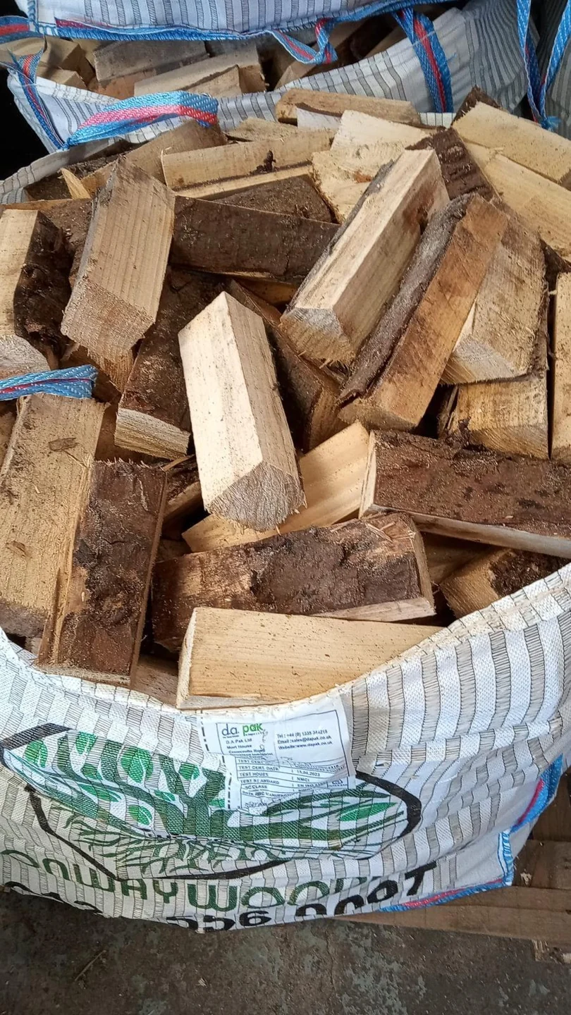 Close view of logs in a branded Monway Woodfuel bulk bag